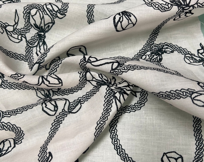 100% Linen designer print, Ivory base with black jewelry designer printed linen. 58” wide Sold by the yard