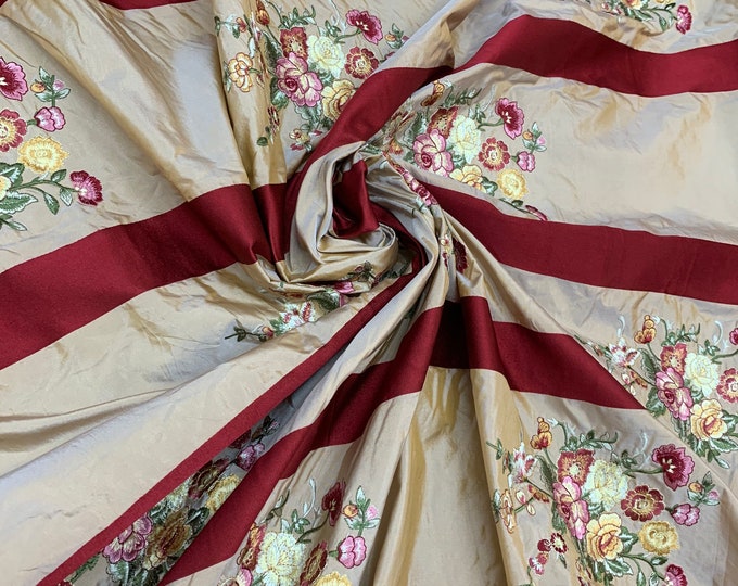 Beautiful gold with wine satin stripes with floral embroidery silk taffeta 54” wide. Best used for home decor. Sold by the yard