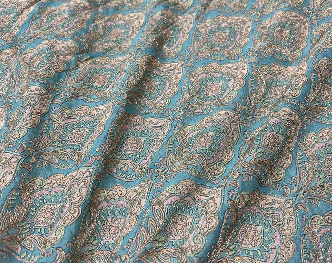 Beautiful soft turquoise base with champagne pink silvers emb 46”wide    Beautiful artistic design embroidered viscose soft chiffon.