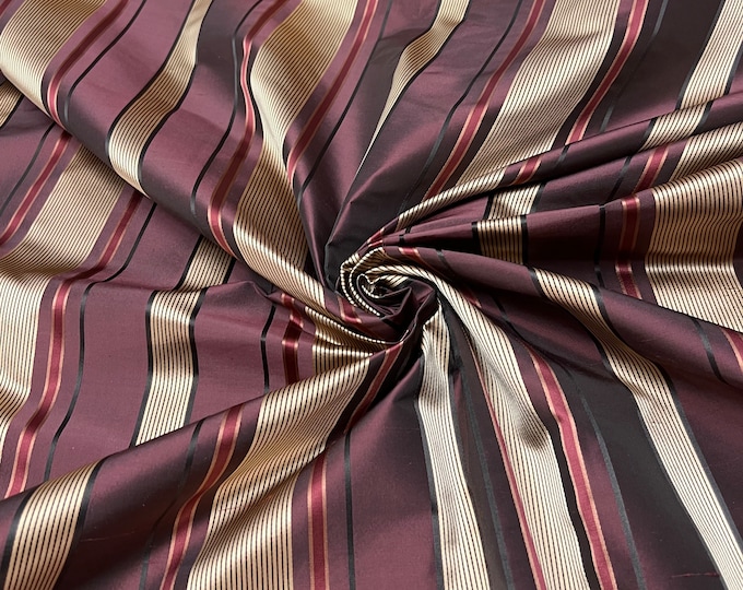 100% silk beautiful butgady wine shades with gold & black satin stripes.  silk satin taffeta 54" wide            Sold by the yard