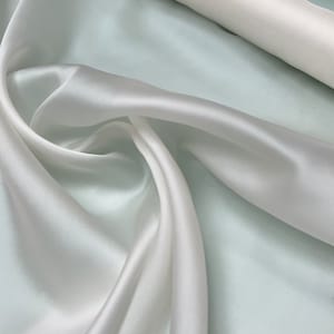 100% silk satin face organza, beautiful white color Silk satin organza also called silk Gazzar. 54” wide. Sold by yard