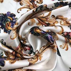 100% silk satin charmeuse digital print 54&quot; wide    Beautiful ivory with gold blue purple floral print silky soft fabric 54” wide