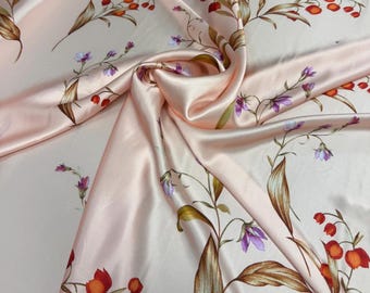 100% silk satin charmeuse digital print 54" wide    Beautiful peach base with orange green copper purple floral design silk fabric 54” wide