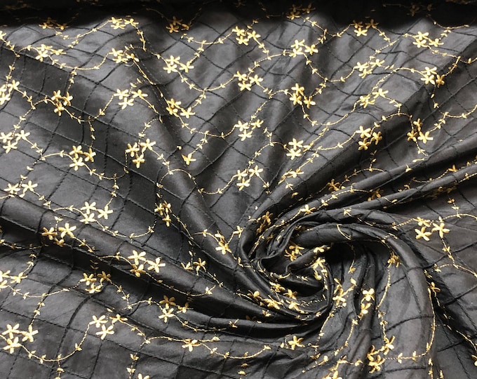 Beautiful 100% silk black pintuck shantung with gold floral embroidery.  Best used for home decor & appreal. Sold by the yard