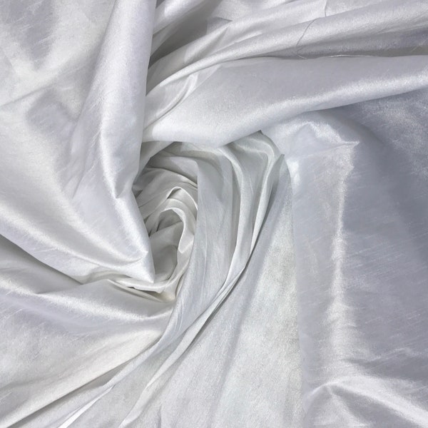 White Shantung/Dupioni fabric. 54" wide. Shantung fabric is unique blend makes this fabric soft and gives structure to dress.