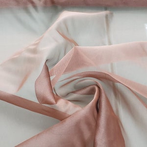 Beautiful taupe rose pink color silk Irredescent organza 54” wide.  Best used for apparel and home Decore.  Sold by the yard