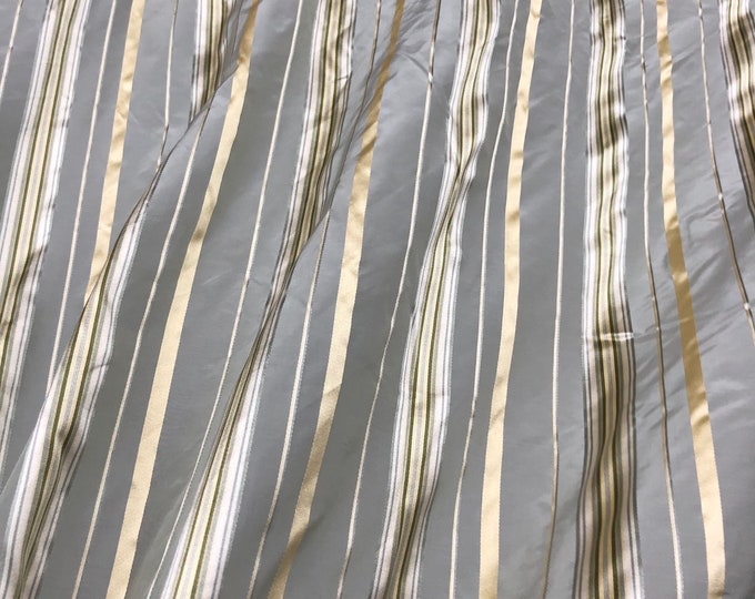 Beautiful gray base silk taffeta with gold satin stripes 54” wide best used for apparel and draperies sold by the yard
