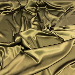 May include: A smooth, silky fabric in a deep olive green color. The fabric is draped and folded, creating soft, flowing lines.