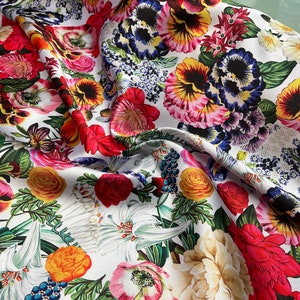 Mikado Zibelline printed fabric 54” wide.  Beautiful white base multi color mix flowers red yellow etc used for apparel.  Sold by the yard