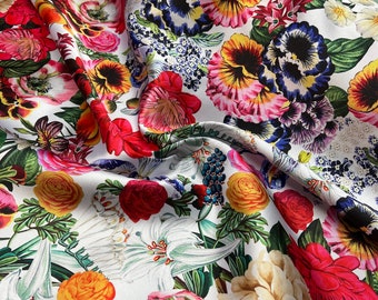 Mikado Zibelline printed fabric 54” wide.  Beautiful white base multi color mix flowers red yellow etc used for apparel.  Sold by the yard