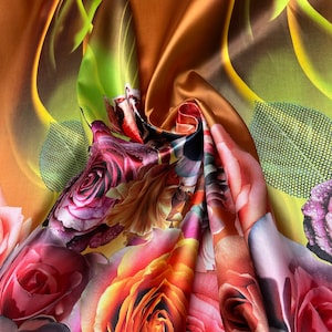 Mikado Zibelline printed fabric 54” wide.  Beautiful mustard yellow ombre base with border style pink shade flowers design used for apparel.