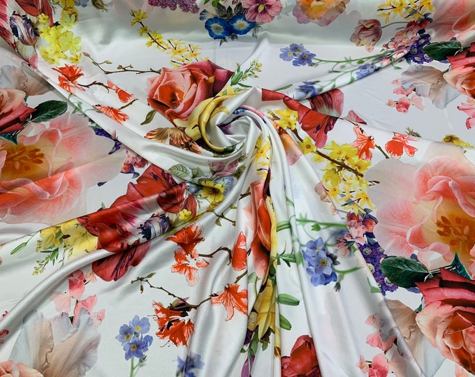 Digital satin Charmouse print 54” wide.  Beautiful whote base with multi color floral print beat used for apparel.  Sold by the yard