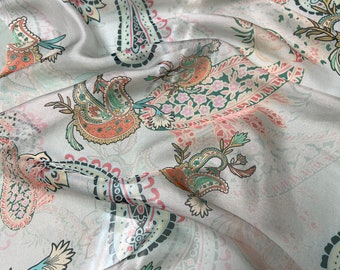 100% silk satin face chiffon digital print 54" wide    Beautiful champagne base with peach orange green tan paisley design
