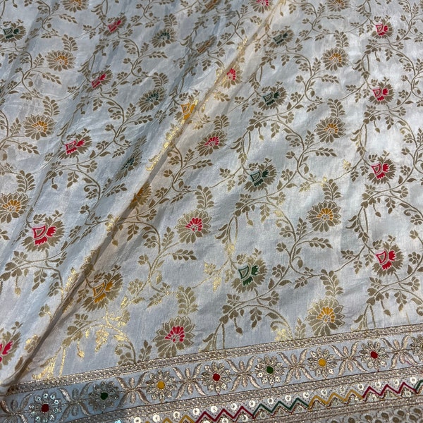 Beautiful ivory base multi color brocade with border mirror style embroidered Shantung 45” wide. Best used for home decor. Sold by the yard