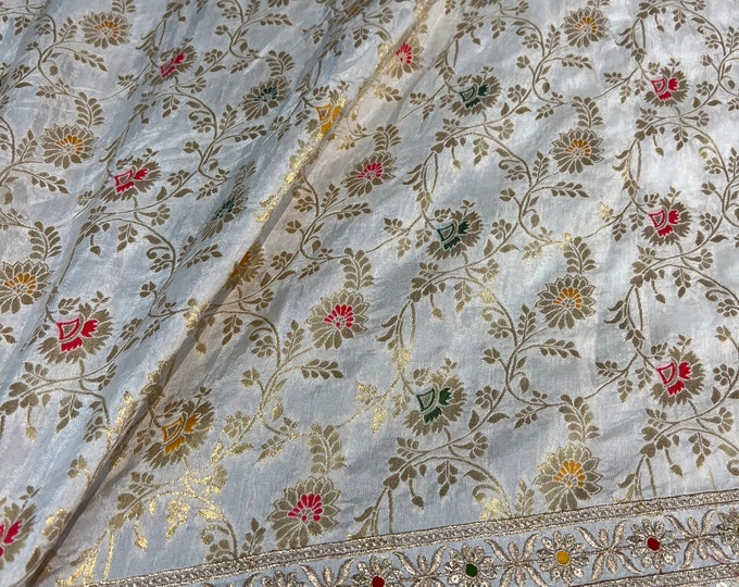 Beautiful ivory base multi color brocade with border mirror style embroidered Shantung 45” wide. Best used for home decor. Sold by the yard