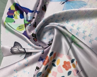 Beautiful light great base woth pastel colors floral butterfly digital print on satin Charmouse 54” wide. Sold by the yard.