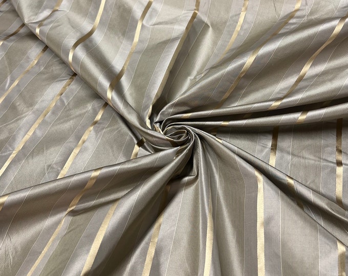 100% silk beautiful beige tan with gold  satin stripes.  silk satin taffeta 54" wide            Sold by the yard