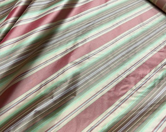 100% silk taffeta stripe 54" wide                      Sold by the yard          Beautiful reddish color with greens & champagne gold shades
