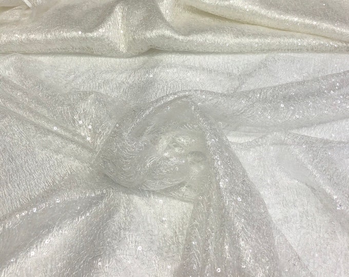 Ivory sequins on swirl mesh fabric 52" wide    Fabric sold by the yard