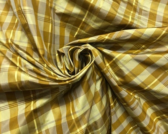 Beautiful copper gold silk taffeta plaids 54” wide. Best used for apparel and home decor sold by the yard