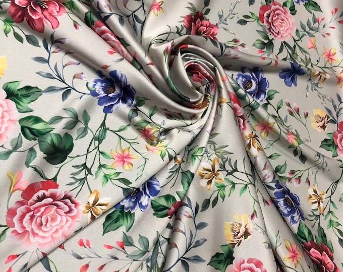 Beautiful multi color floral on ice great base designer print on silky satin 54” wide. Sold by the yard. Best used for apparel