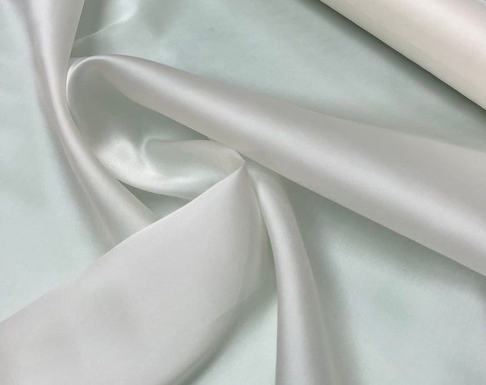 100% silk satin face organza, beautiful ivory color Silk satin organza also called silk Gazzar. 54” wide. Sold by yard