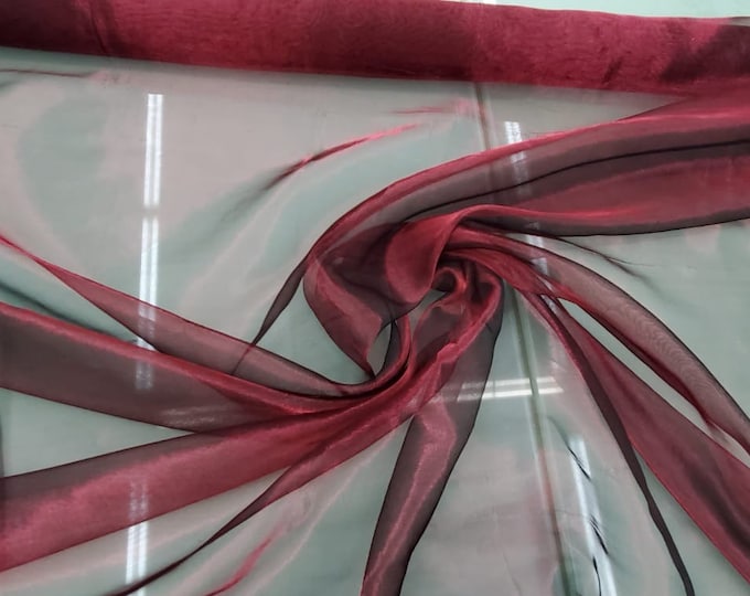 Beautiful wine black Irredescent color silk matalic organza 45” wide.  Best used for apparel. Sold by the yard