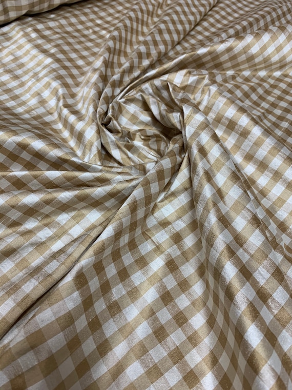 Beautiful taffeta tan and ivory gingham check 54” wide.  Best used for apparel and home Decore.  Sold by the yard