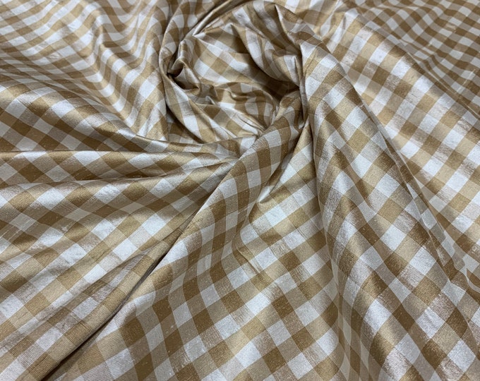 Beautiful 100 % silk shantung tan and ivory gingham check 54” wide.  Best used for apparel and home Decore.  Sold by the yard