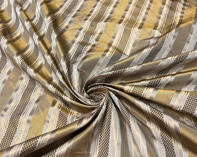 100% silk beautiful beige tan gold copper shades with gold  satin stripes.  silk satin taffeta 54" wide            Sold by the yard