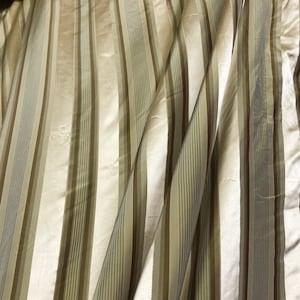 Beautiful taupe and gold silk taffeta satin stripes 54” wide. Best used for home Decore sold by the yard