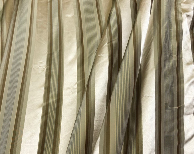 Beautiful taupe and gold silk taffeta satin stripes 54” wide. Best used for home Decore sold by the yard