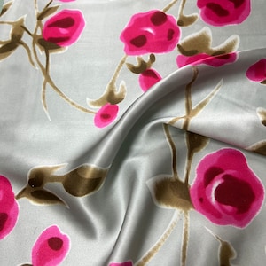 100% silk satin charmeuse digital print 54&quot; wide    Beautiful silver base with shades of Fusia color roses design soft fabric 54” wide