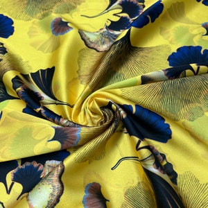 Soft Satin charmeuse digital print 54" wide   Beautiful chartouse base color with blueish floral branded design   Fabric sold by the yard