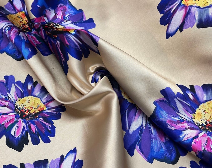 Mikado Zibelline printed fabric 54” wide.  Beautiful canary yellow gold with purple sun yellow flowers used for apparel.  Sold by the yard