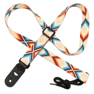 May include: A guitar strap featuring a geometric diamond pattern in shades of cream, teal, orange, and dark red. The strap includes a black plastic adjustment buckle, black leather end tabs with reinforced stitching, and a black nylon tie cord.