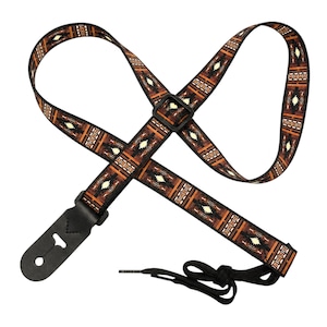 May include: A guitar strap featuring a brown, black, and cream geometric pattern. The strap includes a black plastic adjustment buckle, black leather end tabs with keyhole slots, and a black nylon cord for attachment to the instrument headstock.