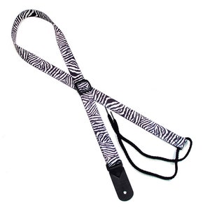 May include: Black and white zebra print guitar strap with a black adjustable strap and a black leather end piece.