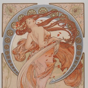 May include: A vintage art nouveau print depicting a woman in a flowing pink dress with long red hair. The woman is standing on a platform with a decorative border around her. The print is in shades of pink, orange, and gold.