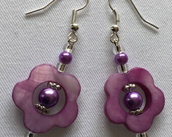 A pair of purple dangly earrings