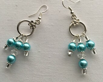 A pair of blue dangly earrings