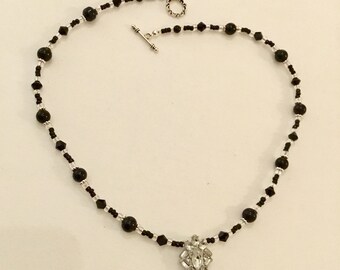 Black beaded necklace with crystal pendant