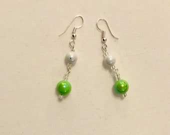 White and green shiny dangly earrings
