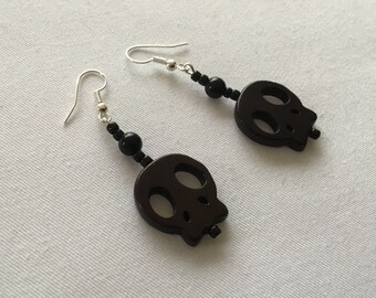 Black skull dangly earrings