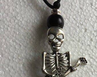 Skeleton with guitar black thong necklace