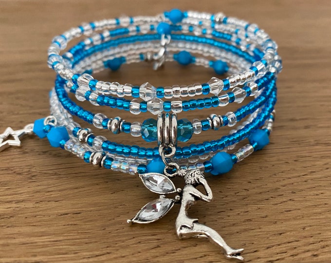Featured listing image: Blue Memory Wire Bracelet with Fairy Charm