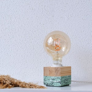 An Edison table lamp which highlights the natural beauty of each individual unique wood. Handmade wooden table lamps are one of interior decor favorites, as they add to the main lighting and add style to interior decoration.