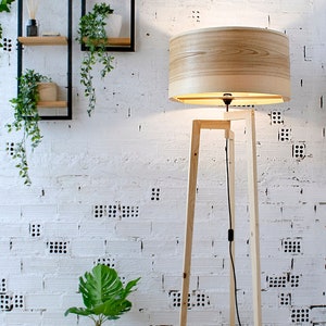 Handmade Wooden Floor Lamp with tripod base and natural wooden shade. A modern wooden floor lamp is the detail that will alter your homes mood.