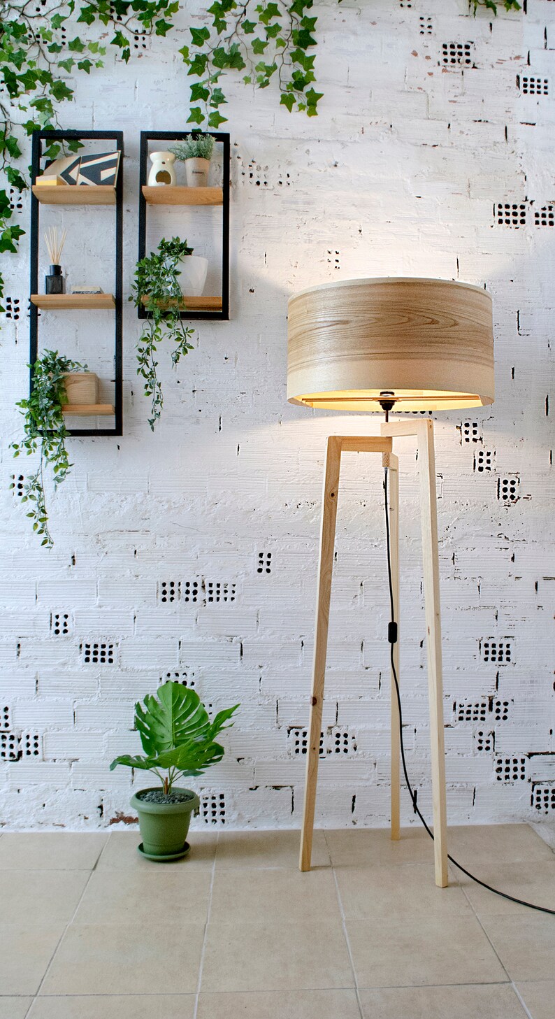 Handmade Wooden Floor Lamp with tripod base and natural wooden shade. A modern wooden floor lamp is the detail that will alter your homes mood.