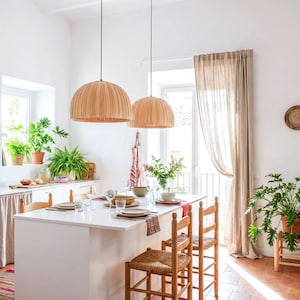 Maple wood pendant light Bell Maple Scandinavian ceiling lamp hanging above dining table with warm glow
